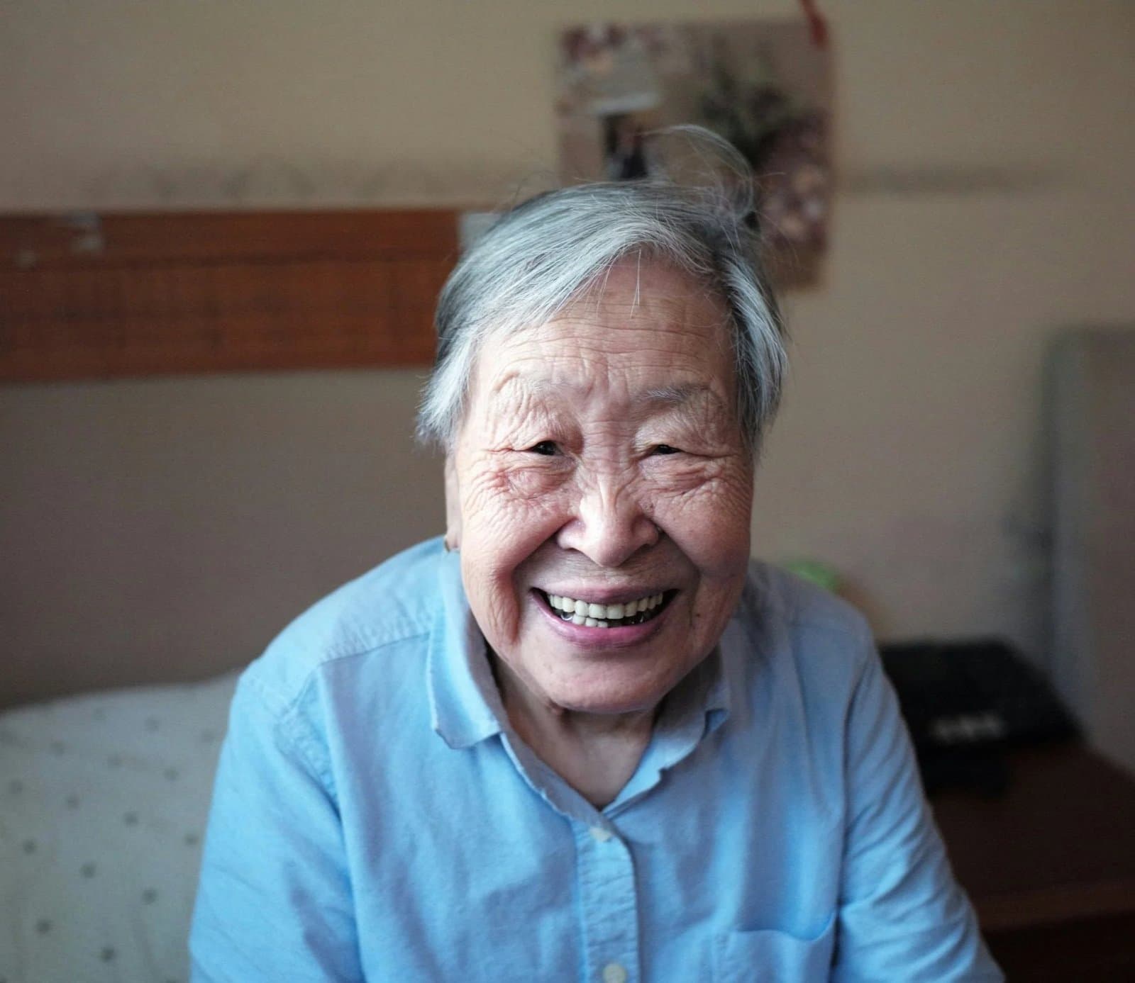 An older woman smiling warmly.